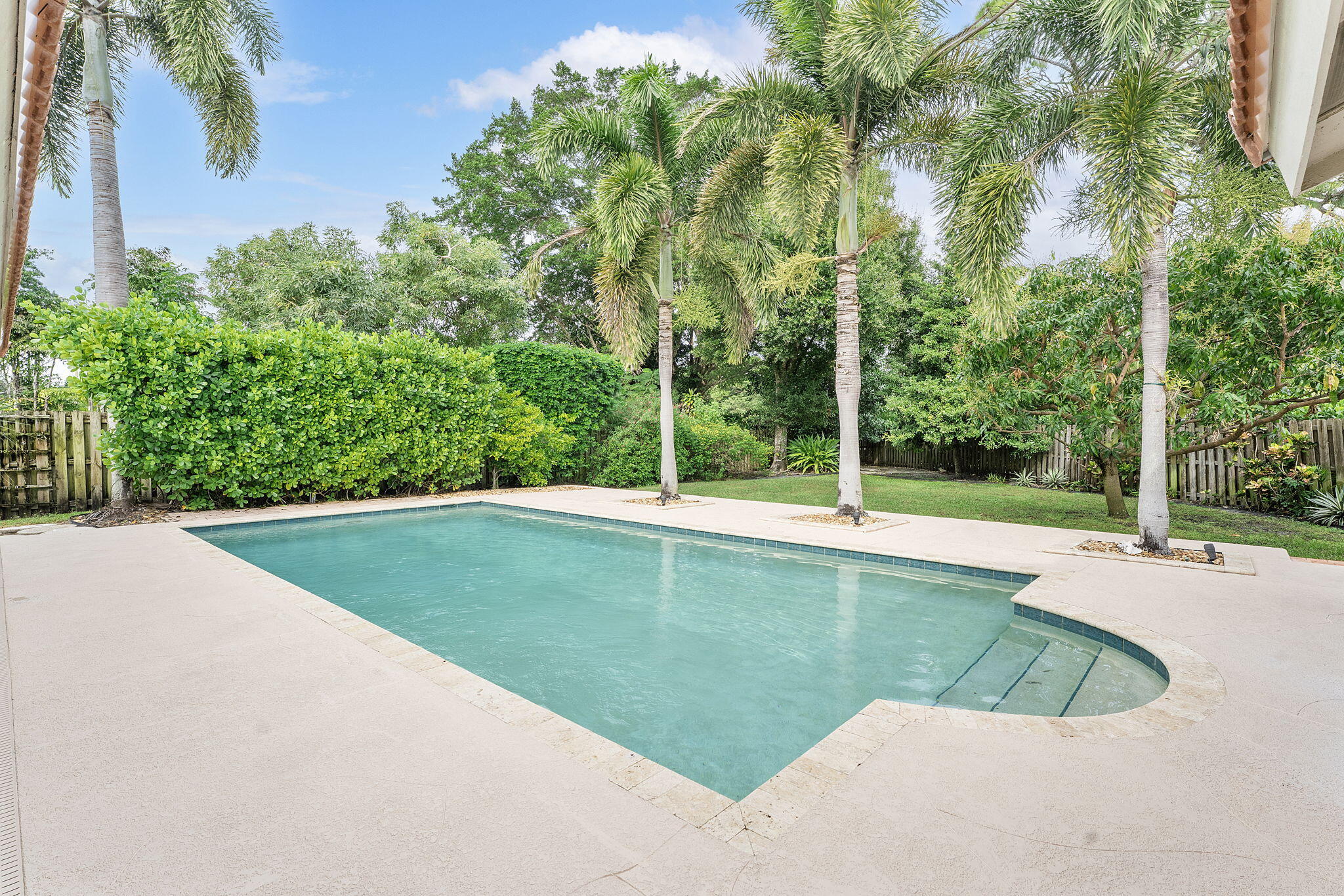 2415 Northwest 31st Street Boca Raton, FL 33431 - Photo 32 of 41 a view of a swimming pool and trees in the background