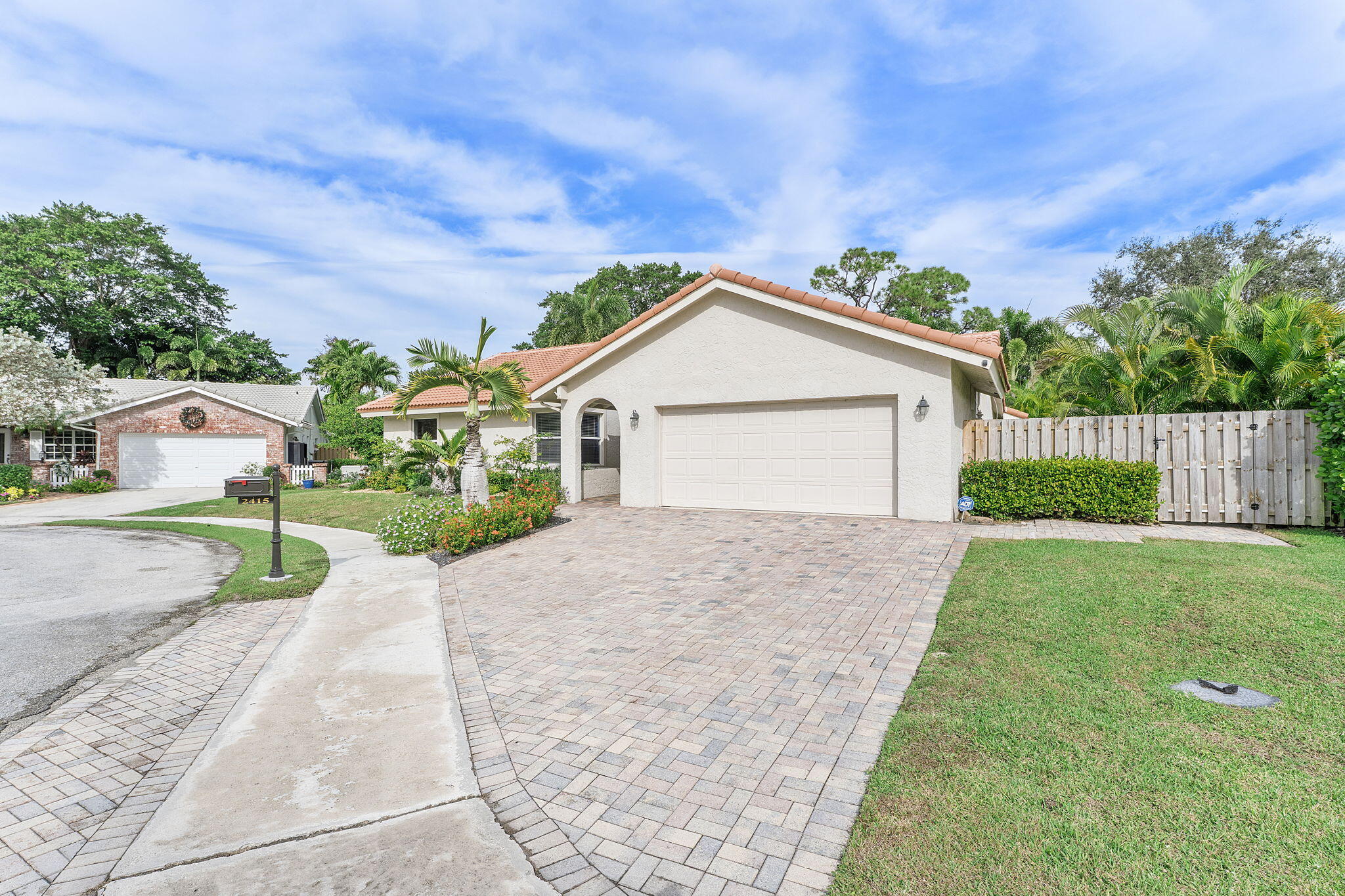 2415 Northwest 31st Street Boca Raton, FL 33431 - Photo 39 of 41 a front view of a house with a yard and garage