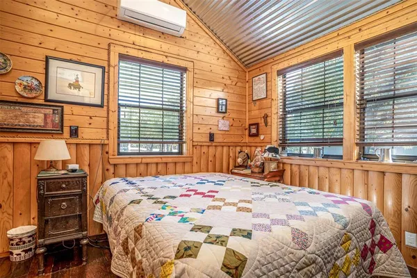 a bedroom with a bed next to a window