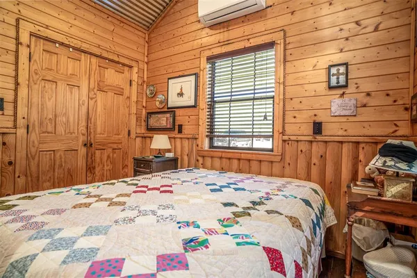 a bed sitting in a bedroom next to a window