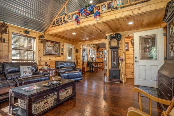 a living room with furniture a wooden floor and a fireplace