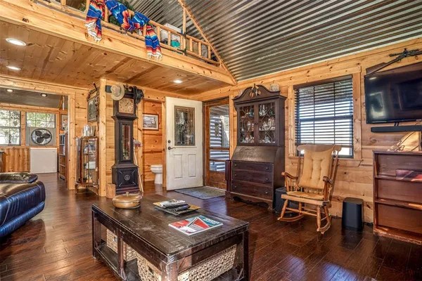 a living room with furniture a wooden floor and next to a window