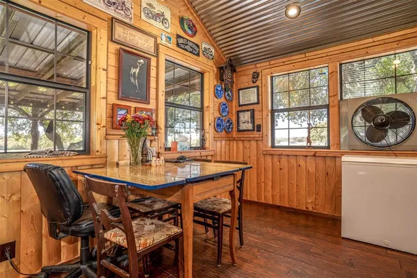 a dining room with furniture a rug and wooden floor