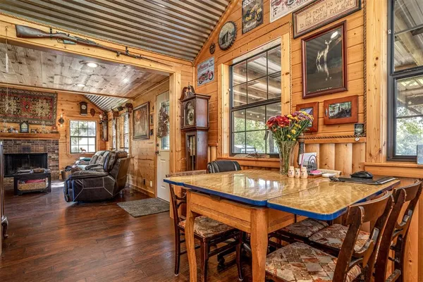 a dining room with furniture window and wooden floor