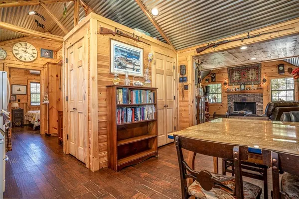 a dining room with furniture and wooden floor