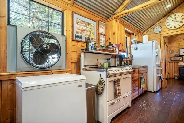 a kitchen with stainless steel appliances a stove a sink and a refrigerator