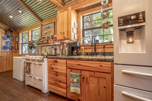 a kitchen with stainless steel appliances granite countertop a stove and a sink