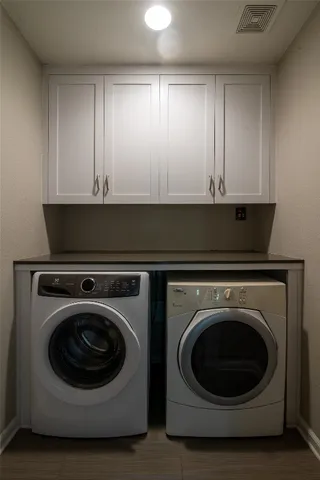 a utility room with sink dryer and washer