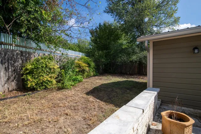 a view of backyard with outdoor seating and green space