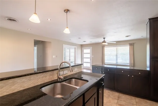 a kitchen with granite countertop a sink and a window