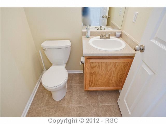 7832 Coffee Road Peyton, CO 80831 - Photo 9 of 19 MAIN LEVEL POWDER ROOM WITH NEW TILE AND FIXTURES FOR YOUR GUESTS AND EASY ACCESS FOR THE MAIN LEVEL