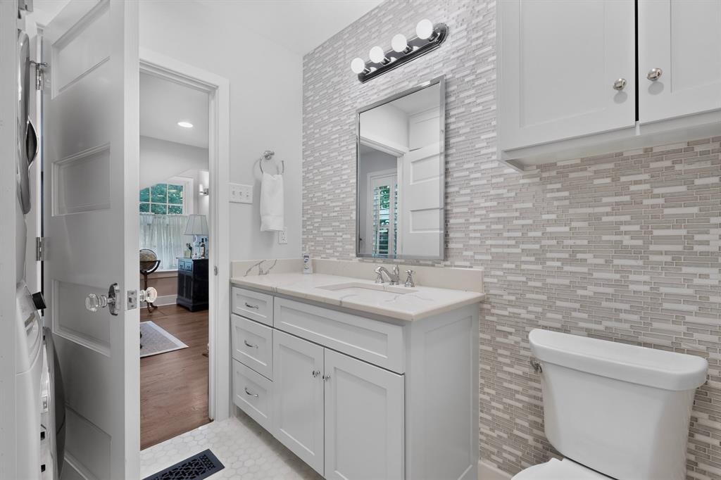 4548 Roland Avenue, Unit A Dallas, TX 75219 - Photo 27 of 31 Vanity with a single basin, undermount sink, and white cabinetry
