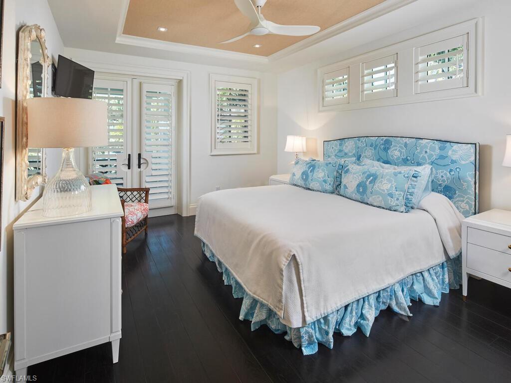 167 4th Street North Naples, FL 34102 - Photo 19 of 33 a spacious bedroom with a bed and a couch