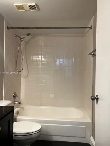 a bathroom with a shower and a toilet