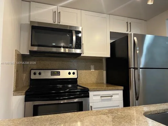 a kitchen with a stove and a refrigerator