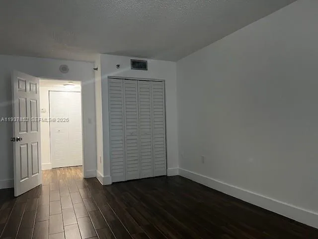 an empty room with wooden floor