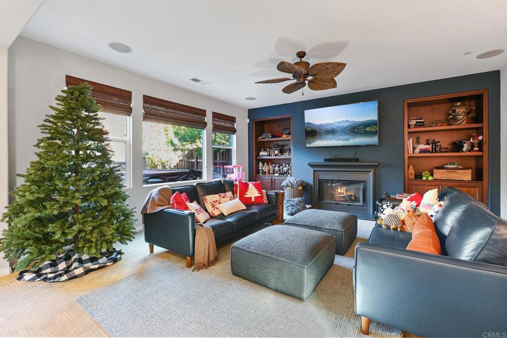 3524 North Fork Avenue Carlsbad, CA 92010 - Photo 13 of 37 a living room with furniture a fireplace and a flat screen tv