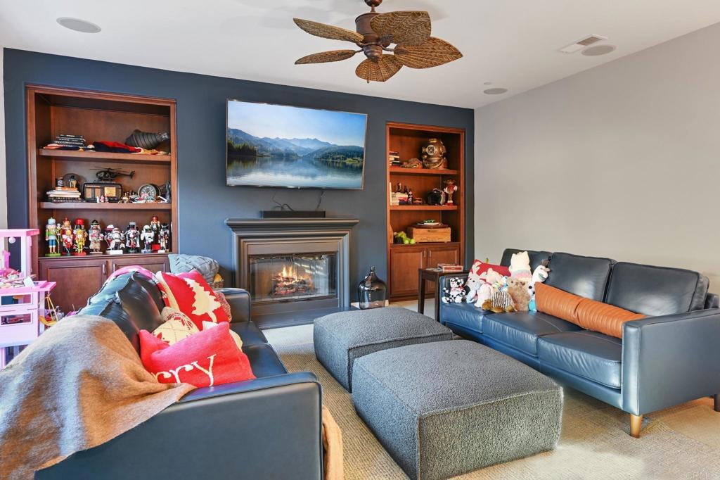 3524 North Fork Avenue Carlsbad, CA 92010 - Photo 14 of 37 a living room with furniture fireplace and a flat screen tv
