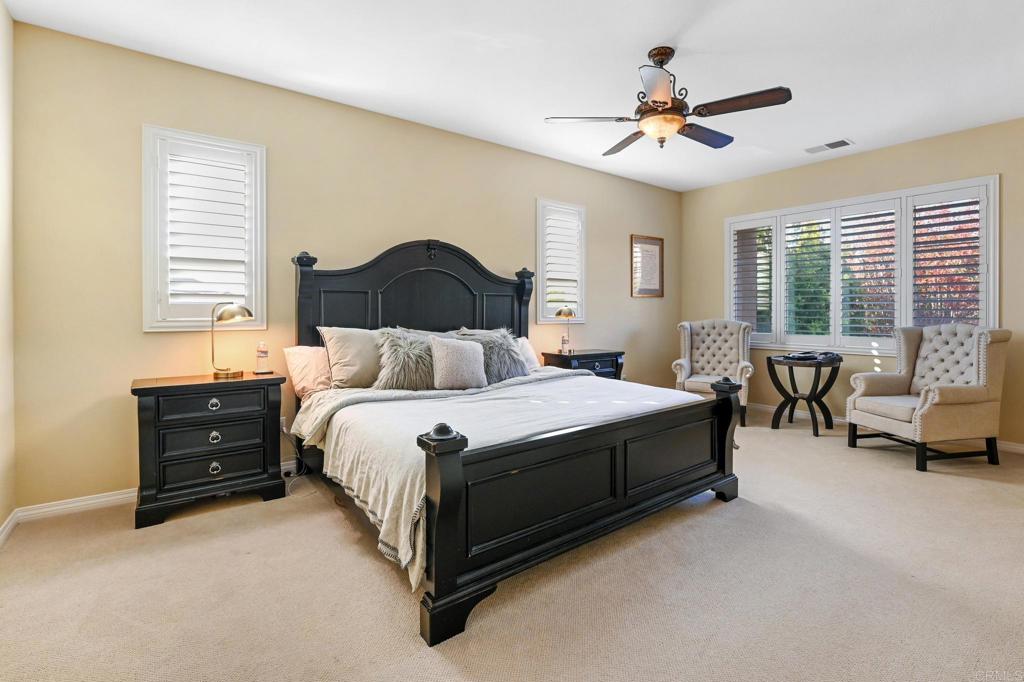 3524 North Fork Avenue Carlsbad, CA 92010 - Photo 22 of 37 a spacious bedroom with a bed and a couch