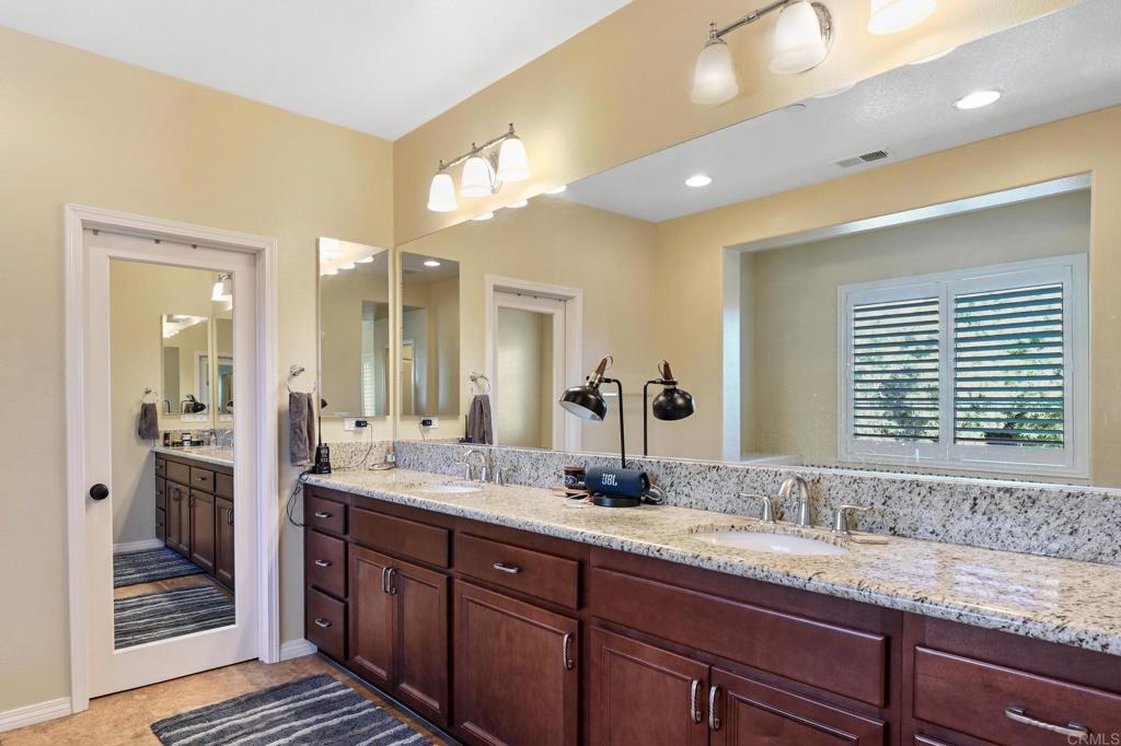 3524 North Fork Avenue Carlsbad, CA 92010 - Photo 24 of 37 a bathroom with a granite countertop sink and a mirror