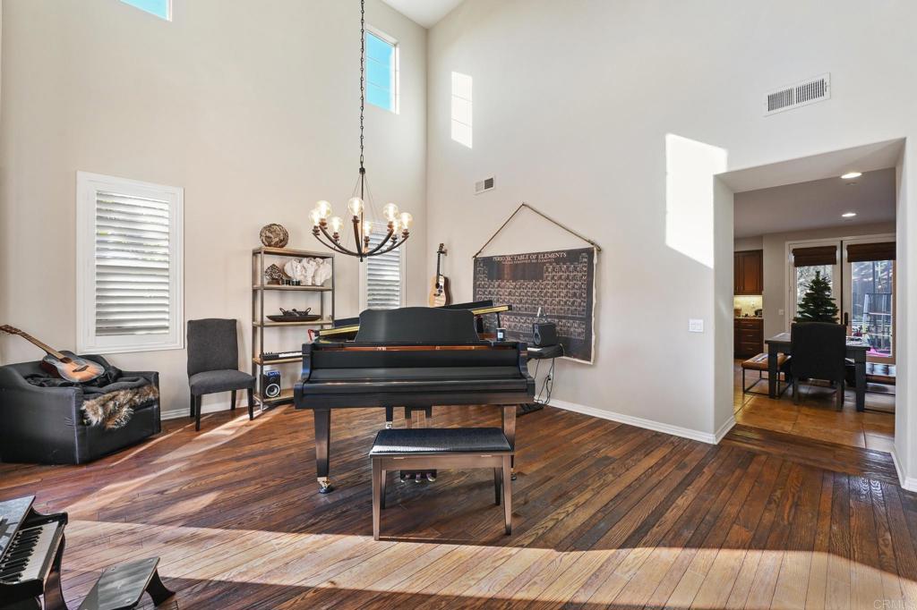 3524 North Fork Avenue Carlsbad, CA 92010 - Photo 5 of 37 a living room with furniture a dining table with wooden floor and a large window