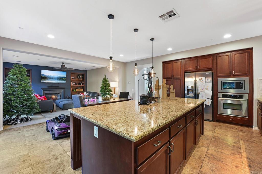 3524 North Fork Avenue Carlsbad, CA 92010 - Photo 9 of 37 a kitchen with stainless steel appliances granite countertop a sink refrigerator and cabinets