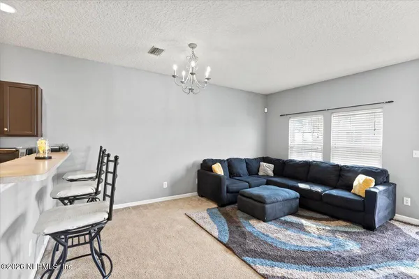a living room with furniture a ceiling fan and a window