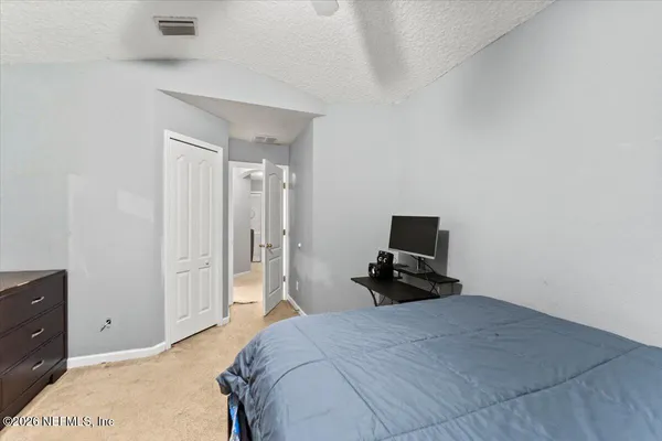 a bedroom with a bed and flat screen tv
