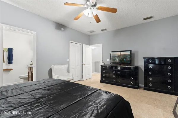 a bedroom with a bed and a mirror