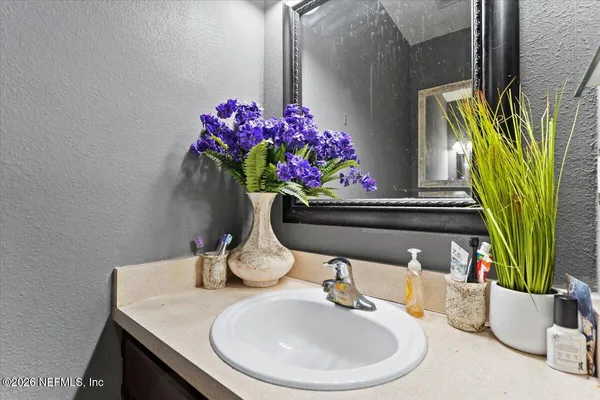 a bathroom with a sink toilet and a mirror