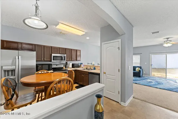 a kitchen with a refrigerator and a stove