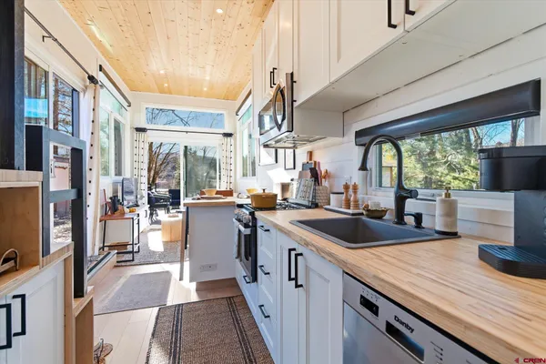 a kitchen with sink stove and refrigerator