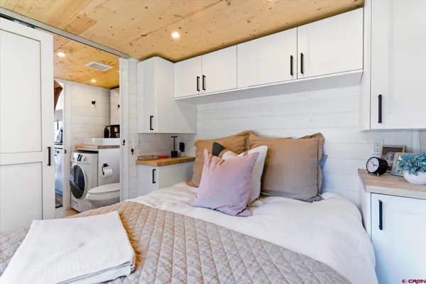 a bedroom with a bed and a sink