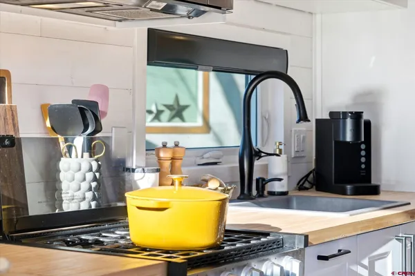 a bedroom with furniture and a large window