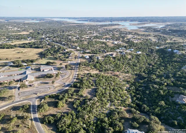 an aerial view of residential houses with city view