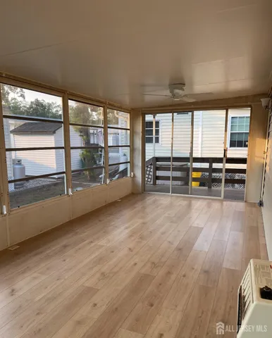 a view of a room with wooden floor and windows