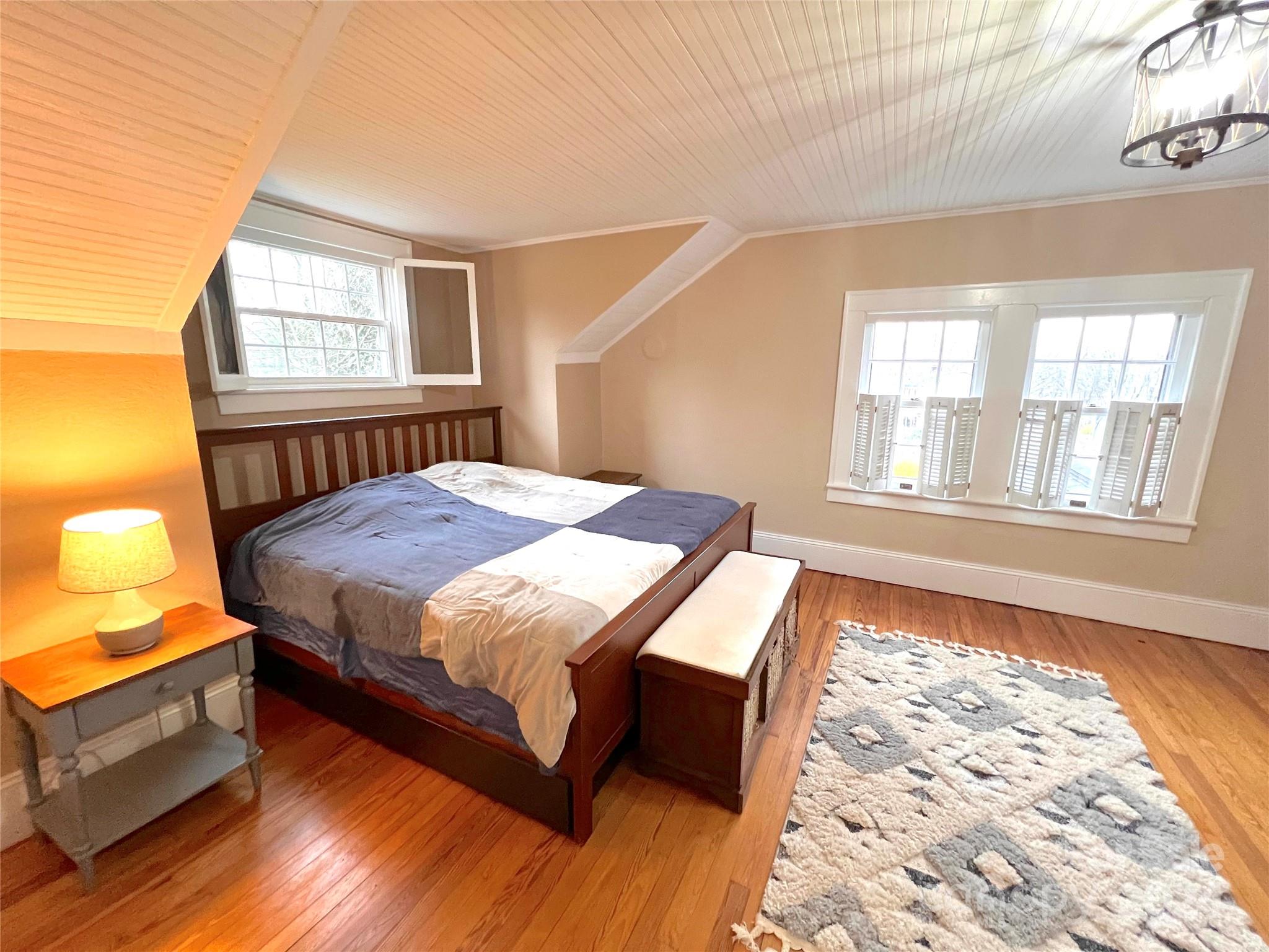 461 Chimney Rock Road Rutherfordton, NC 28139 - Photo 23 of 39 a bedroom with a bed and wooden floor