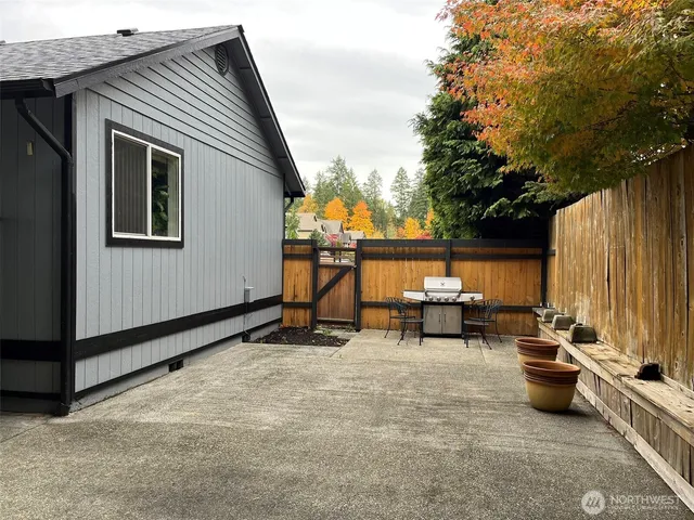 a view of a house with backyard and sitting area