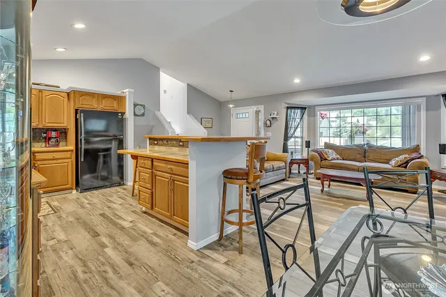 a living room with fireplace furniture and a wooden floor