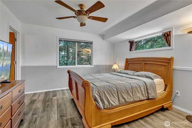 a bedroom with a bed and a flat screen tv