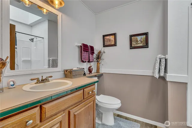 a bathroom with a sink toilet and a mirror