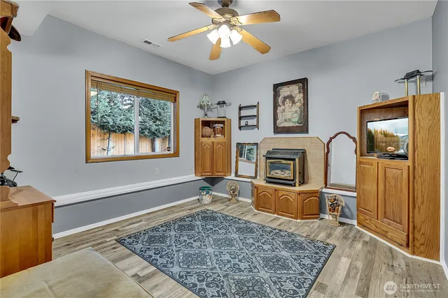 a living room with fireplace furniture and a window