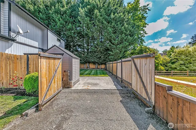 a view of a pathway with a wrought fence