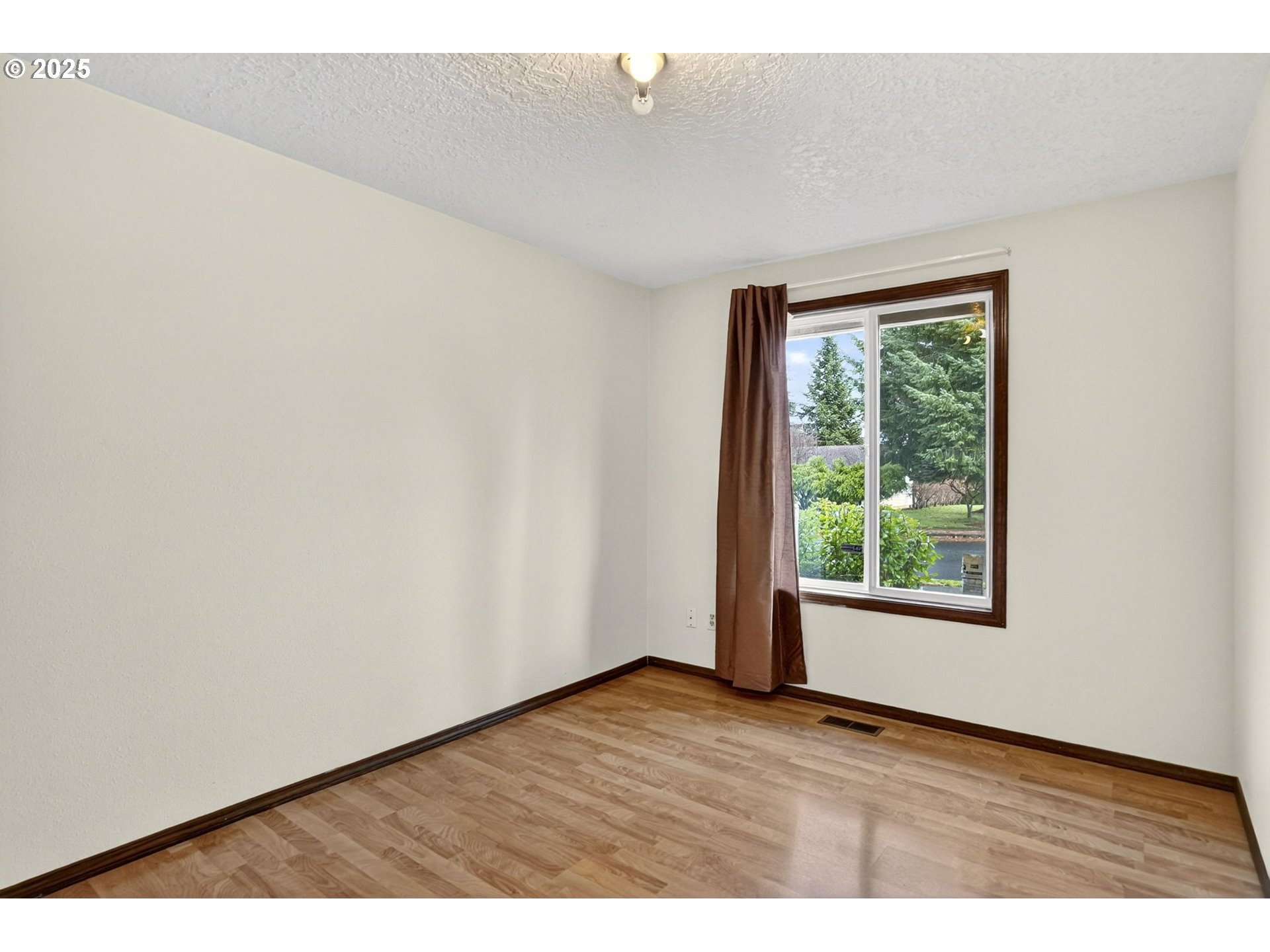 1427 Southeast Wendy Avenue Gresham, OR 97080 - Photo 22 of 35 an empty room with wooden floor and windows