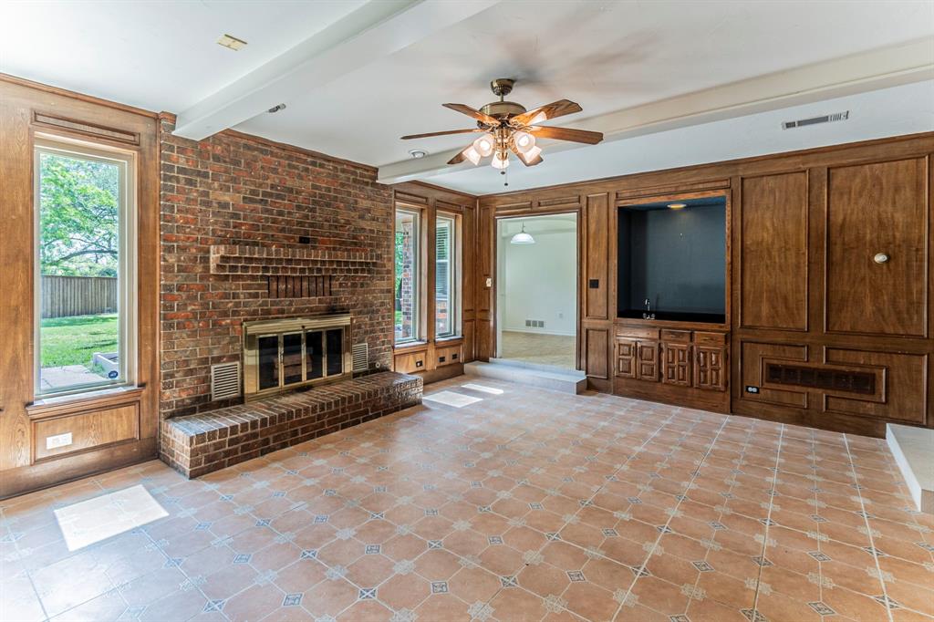127 Nicklaus Nook Lancaster, TX 75146 - Photo 7 of 37 Unfurnished living room featuring a fireplace, ceiling fan, and beam ceiling