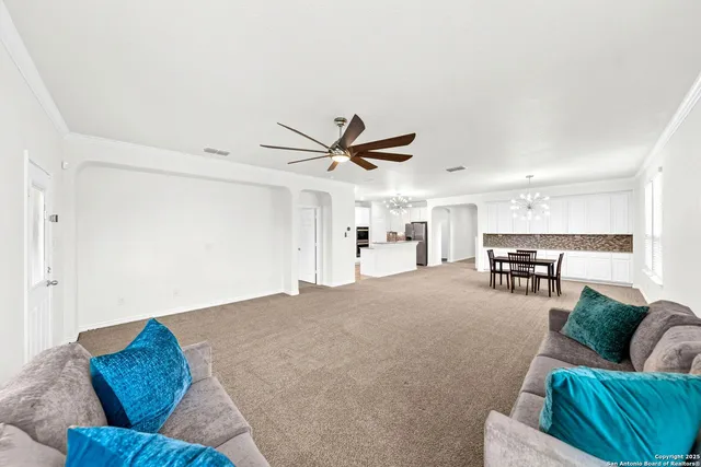 a living room with furniture and kitchen view