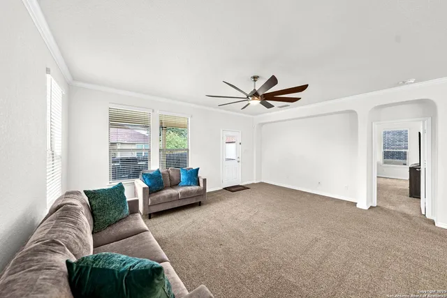a living room with furniture and a large window