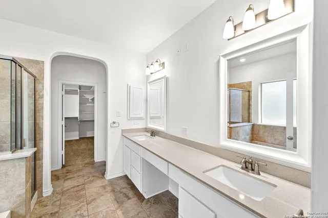 a spacious bathroom with a double vanity sink mirror and