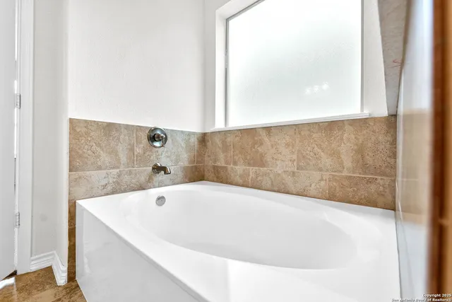 a white bath tub sitting in a bathroom