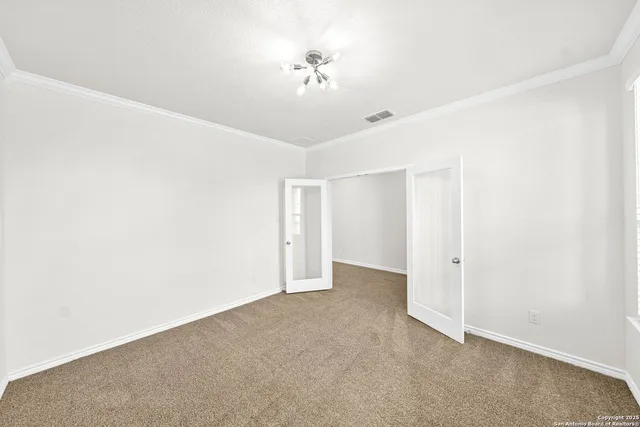 an empty room with a ceiling fan and a window